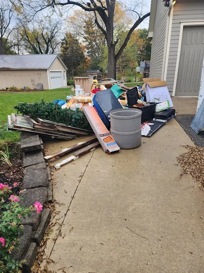 Dumpster being loaded with debris for Residential Dumpster Rental in Pittsboro